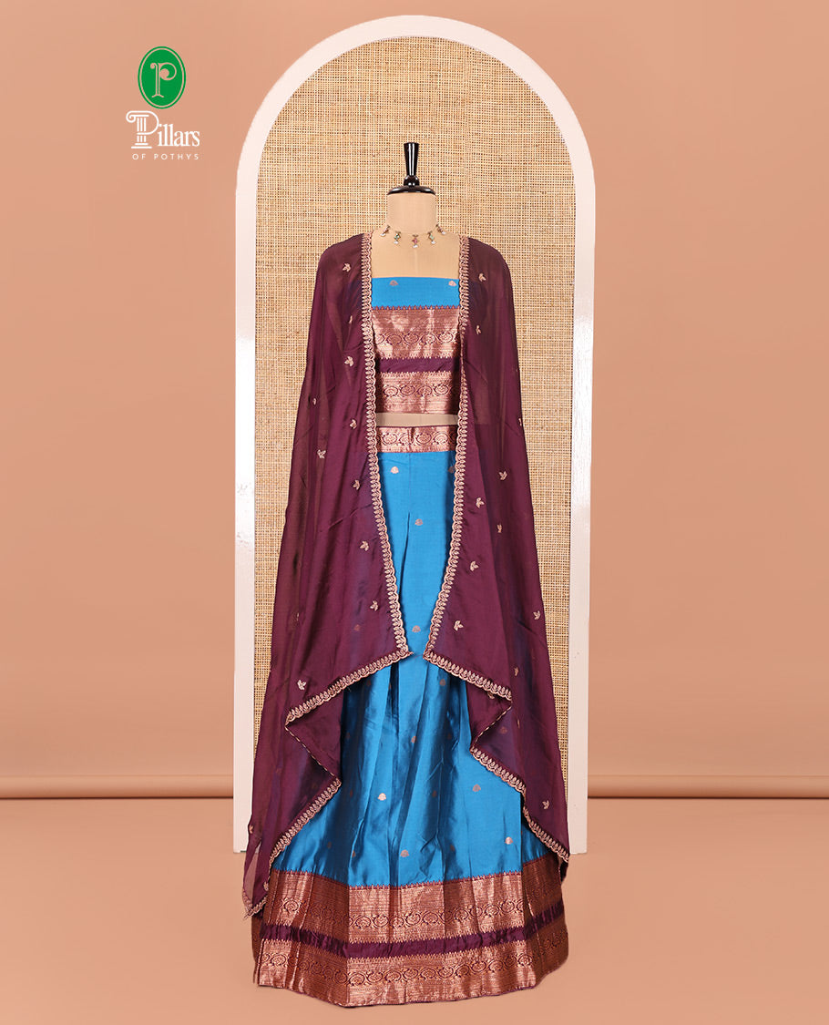 Blue and Purple Semi-Banarasi Half-Saree Featuring Zari Buttas Skirt, Complemented by Contrast Rettai Pettu, Traditional Border of Floral Creeper Designs, Paired with a Matching Blouse, and a Satin Georgette Embroidered Scallop Dhavani