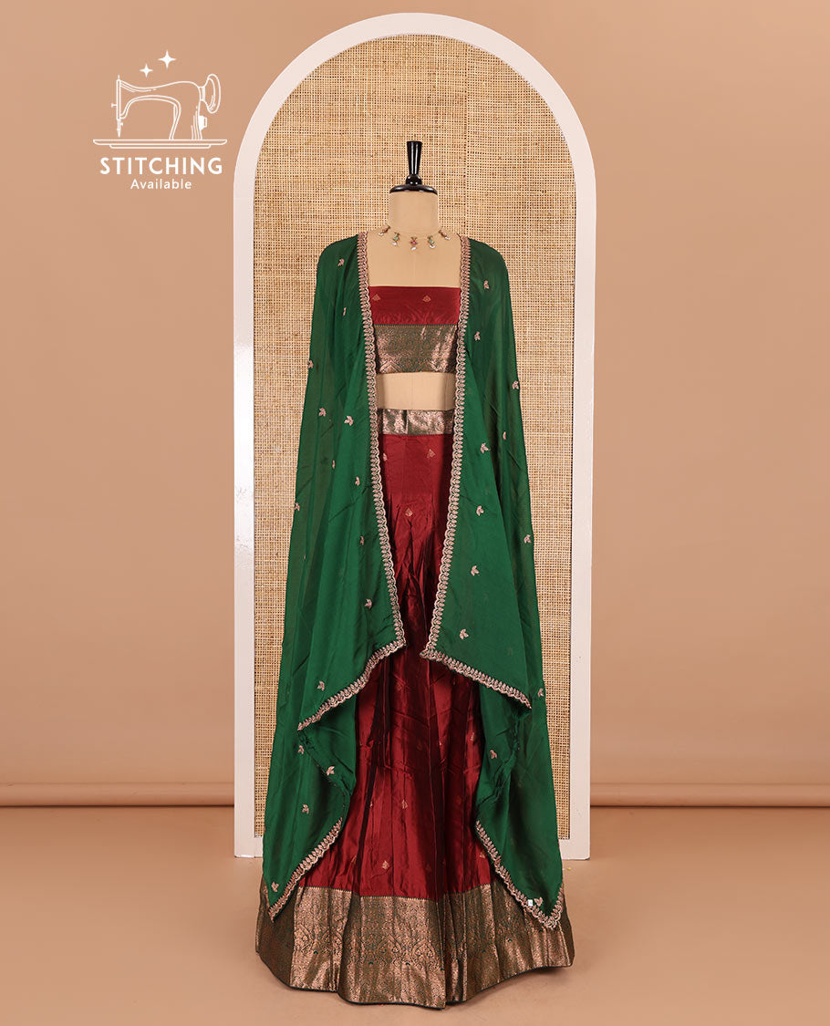 Maroon taffeta silk half-saree, zari buttas with contrast traditional zari bordered skirt, matching zari design blouse, and contrast scallop buttas embroidered dhavani