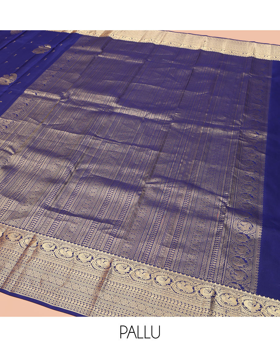 Blue Vasundhara Silk Saree, Decorated with Zari Buttas All Over Its Body, Highlighted by Zari Border of Rekku, Muthu, Mayil, Manga, Muthu, Kathir, Laddu Kamalam, and Cross Neli Designs, Pallu Mirrors the Same Designs, and Paired with a Matching Blouse