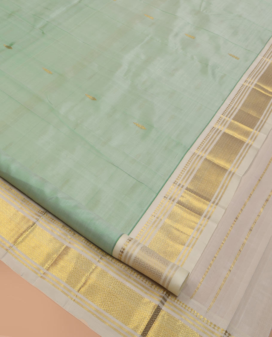 Pale Green Kanchipuram Silk Saree, Woven with Zari Buttas, Complemented by a Contrast One-Sided Border of Panner Sombu, Banaras, and Mayil Kann Designs, Zari Woven Pallu, and a No Blouse