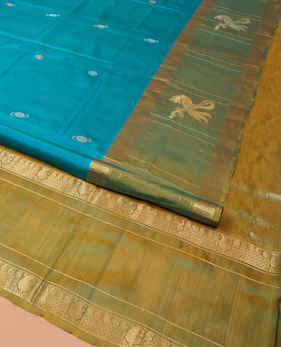 Blue Uppada Silk Saree Graced with Zari Buttas, Complemented by a Contrast Traditional Zari Border of Peacock Veena Designs, Contrast Pallu of Floral Jaal Designs, and Paired with a Contrast Blouse