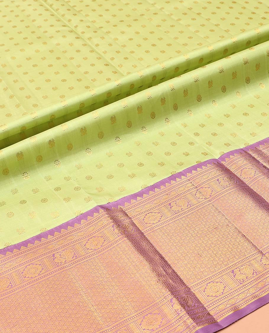Green Pure Silk Half-Saree, Artfully Detailed with Mayil-Chakram Buttas on Its Skirt, Complemented by a Contrast Border of Rekku, Muthu, Diamond, Chakram, and Jaal Designs, Comes with a Contrast Blouse and a Dhavani of Jacquard Design