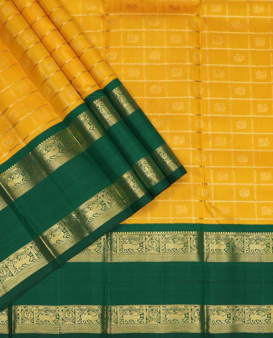 Yellow pure silk half saree, mayil chakram enclosed neli checked skirt, contrast rettai pettu border and blouse of thilakam mokku, muthu, mayil and yaali design and intricate pallu