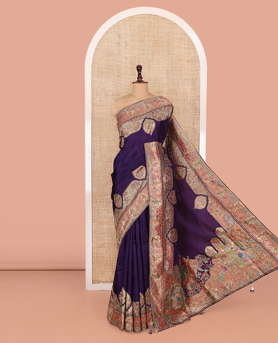 Violet Dola Silk Saree, Uniquely Detailed with Patch Embroidery on Its Body, Highlighted by a Patch Embroidered Border, Pallu Depicts Flora, Fauna, and Human Design Embroidery, and Paired with a Matching Blouse