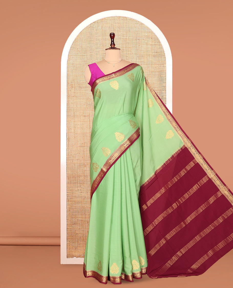 Green Mysore Silk Saree Prettified with Zari Buttas All Over Its Body, Complemented by Captivating Contrast Border of Traditional Zari Designs, Zari Designs Woven Pallu, and Paired with a Contrast Blouse