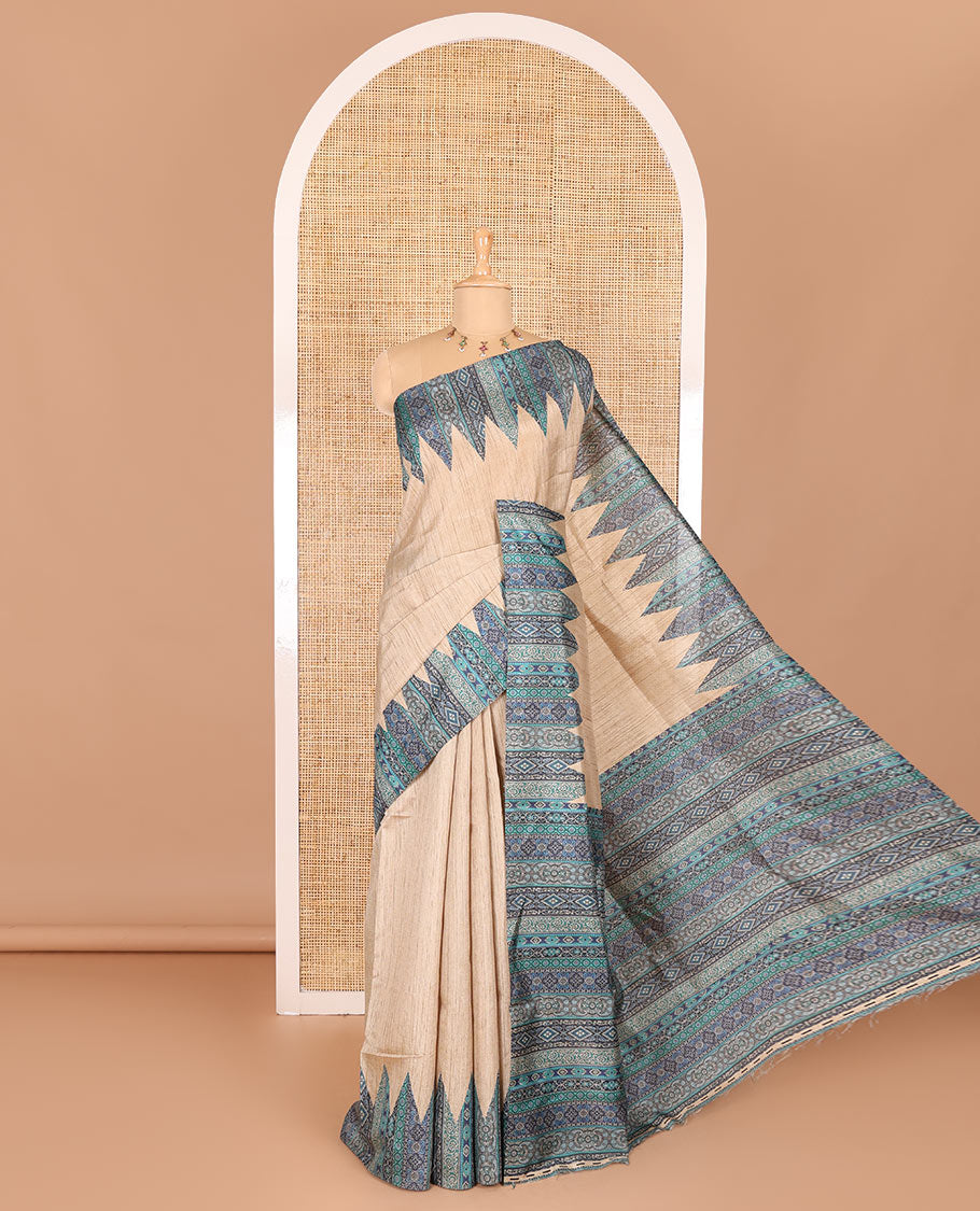 Chikku and blue plain Khicha Tussar saree, temple border of intricate Ajrakh print, Ajrakh printed pallu, and contrast Ajrakh printed blouse