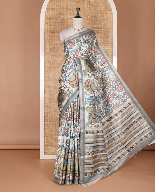 Cream-base multi-color kalamkari floral-vine and peacocks printed semi-tussar saree, gold zari piping border, kalamkari printed pallu, and contrast printed blouse