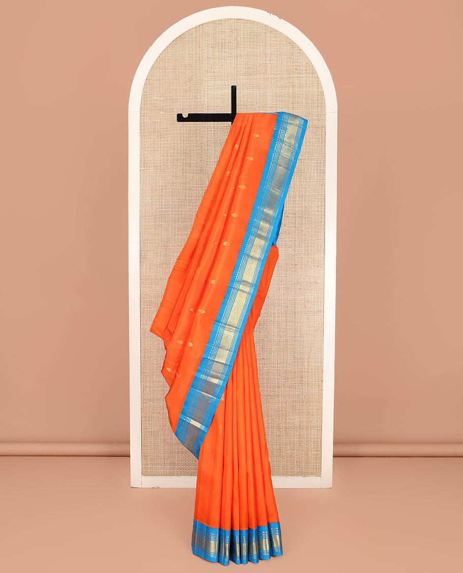 Orange Kanchipuram Silk Saree, Subtly Enriched with Zari Buttas on Its Body, Complemented by Contrast One-Sided Korvai Border of Rekku, Banaras, Muthu, and Mayil Kann Designs, Pallu Depicts Zari Designs, and Comes Without a Blouse