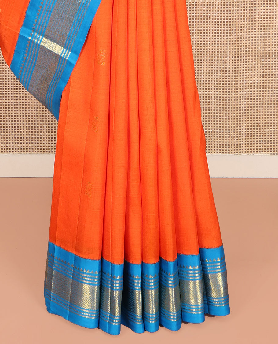 Orange Kanchipuram Silk Saree, Subtly Enriched with Zari Buttas on Its Body, Complemented by Contrast One-Sided Korvai Border of Rekku, Banaras, Muthu, and Mayil Kann Designs, Pallu Depicts Zari Designs, and Comes Without a Blouse