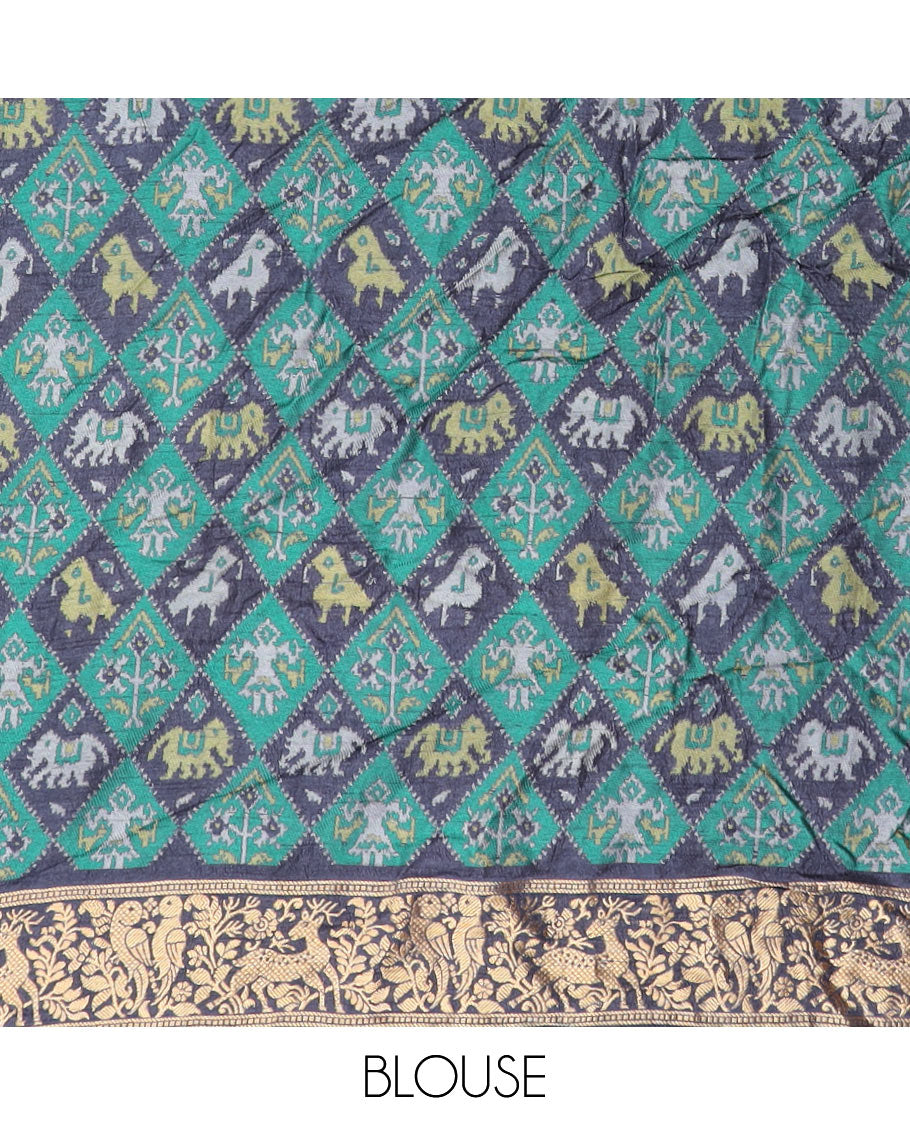 Blue bandhani dots and Pichwai cow motifs bandhani silk saree, contrast Pichwai cow and animal motifs zari border, and patola-style butta enclosed jaal pallu