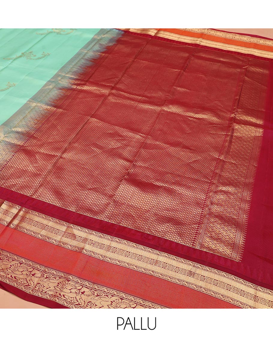 Turquoise Vasundhara Silk Saree, Meticulously Crafted with Zari Buttas on Its Body, Complemented by Contrast Border of Muthu, Mayil Kann, Chakram, Mayil, and Kuthirai Designs, an Intricately Designed Pallu, and Paired with a Contrast Blouse