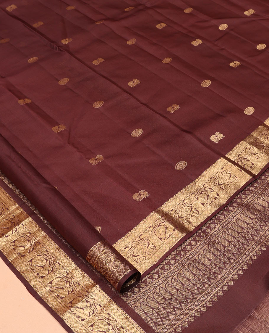 Brown Vasundhara Silk Saree, Enriched with Mayil-Chakram Buttas, a Zari Border of Rekku, Mayil Kann, and Mayil Designs, a Grand Pallu, and a Matching Blouse