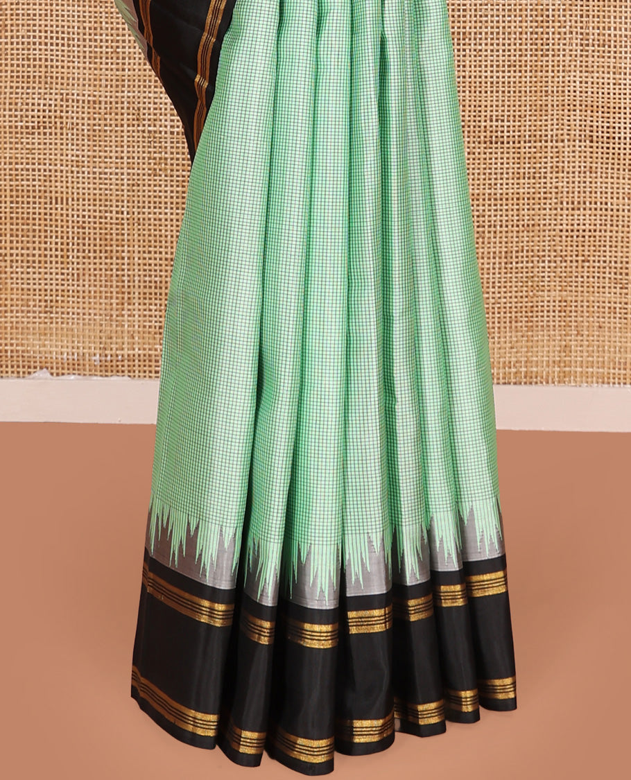 Green micro-checked Kanchipuram silk saree, contrast thazampoo rekku border, and zari striped pallu