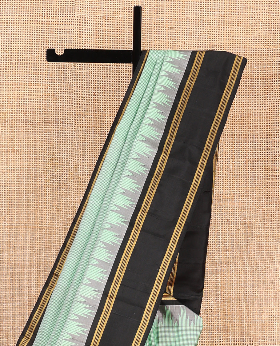 Green micro-checked Kanchipuram silk saree, contrast thazampoo rekku border, and zari striped pallu