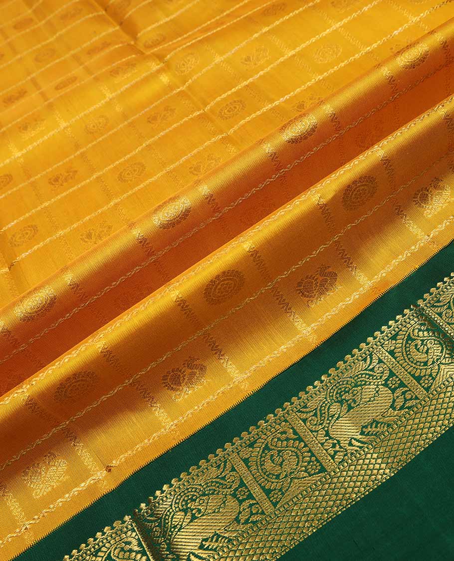 Yellow pure silk half saree, mayil chakram enclosed neli checked skirt, contrast rettai pettu border and blouse of thilakam mokku, muthu, mayil and yaali design and intricate pallu