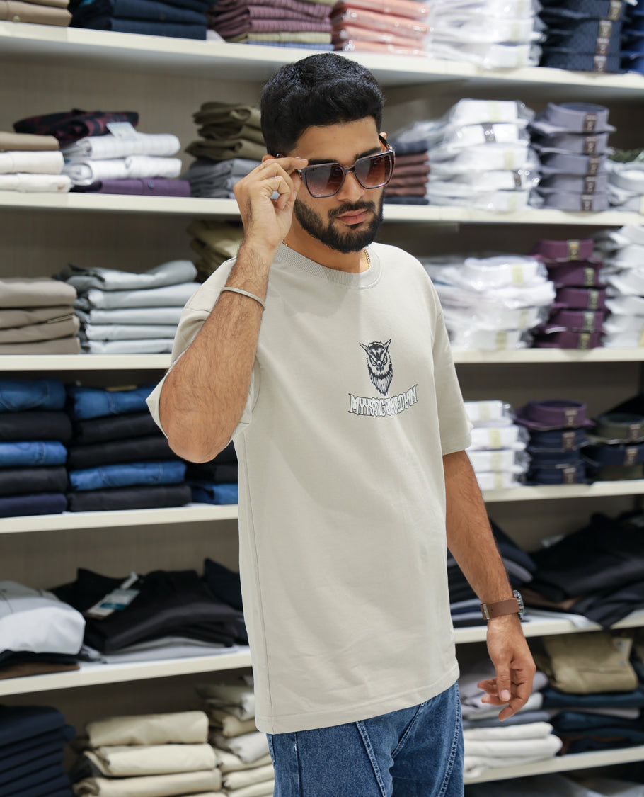 Cream Cotton-Blended T-shirt Features Funky and Bold Motifs Print, Half-Sleeves, Oversized Fit, Round Neck, and Regular Length