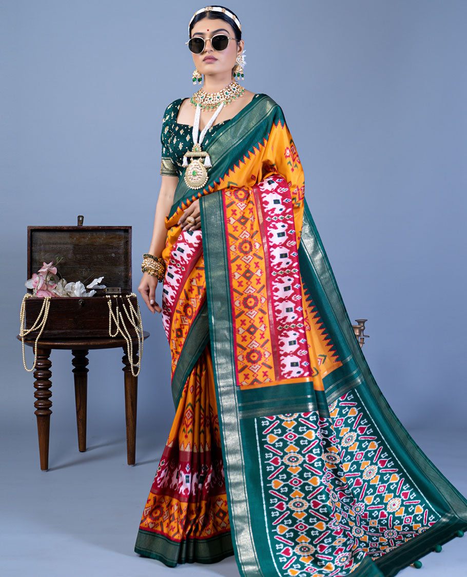 Orange patola floral motifs designer saree, contrast temple border, and patola printed pallu