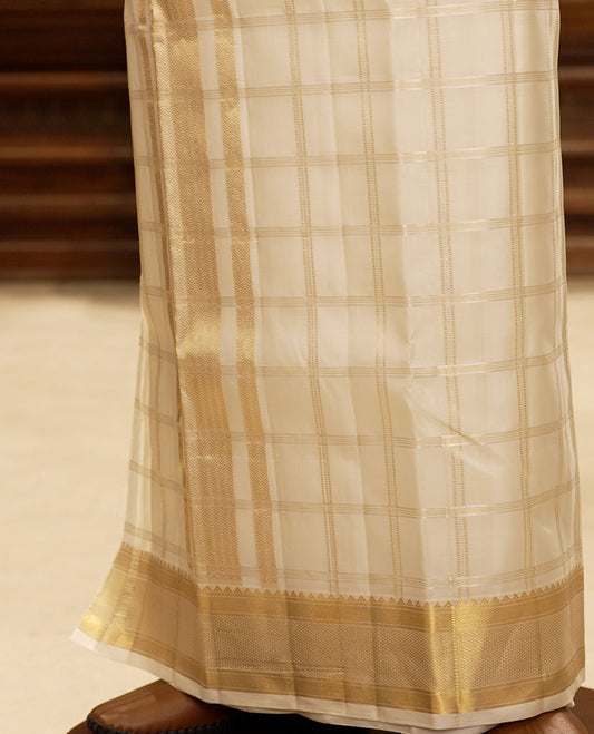 Cream Muthu zari checked pure silk double-layered dhoti with zari border of rekku, banaras, kuyil kann & ara maadam