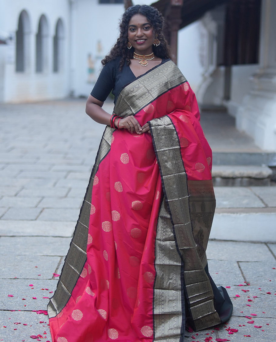 Reddish Orange Budget Silk Saree, Elevated with Floral Zari Buttas All Over Its Body, Complemented by Contrast Traditional Zari Designs Woven Big Border, Grandly Decked Up Pallu, and Paired with a Contrast Blouse