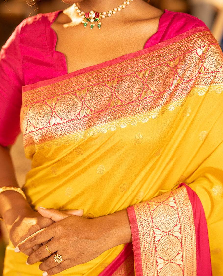 Mustard Yellow Dupion Silk Saree, Embellished with Buttas All Over Its Body, Complemented by Contrast Traditional Border of Paisleys and Chakram Designs, Intricately Designed Pallu, and Paired with a Contrast Blouse