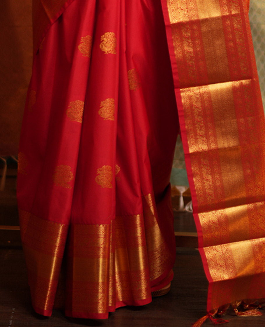 Red Budget Silk Saree, Gleamed Up with Zari Buttas on Its Body, Highlighted by a Zari Border of Traditional Designs, Grand Jaal Design Border, and Paired with a Matching Blouse