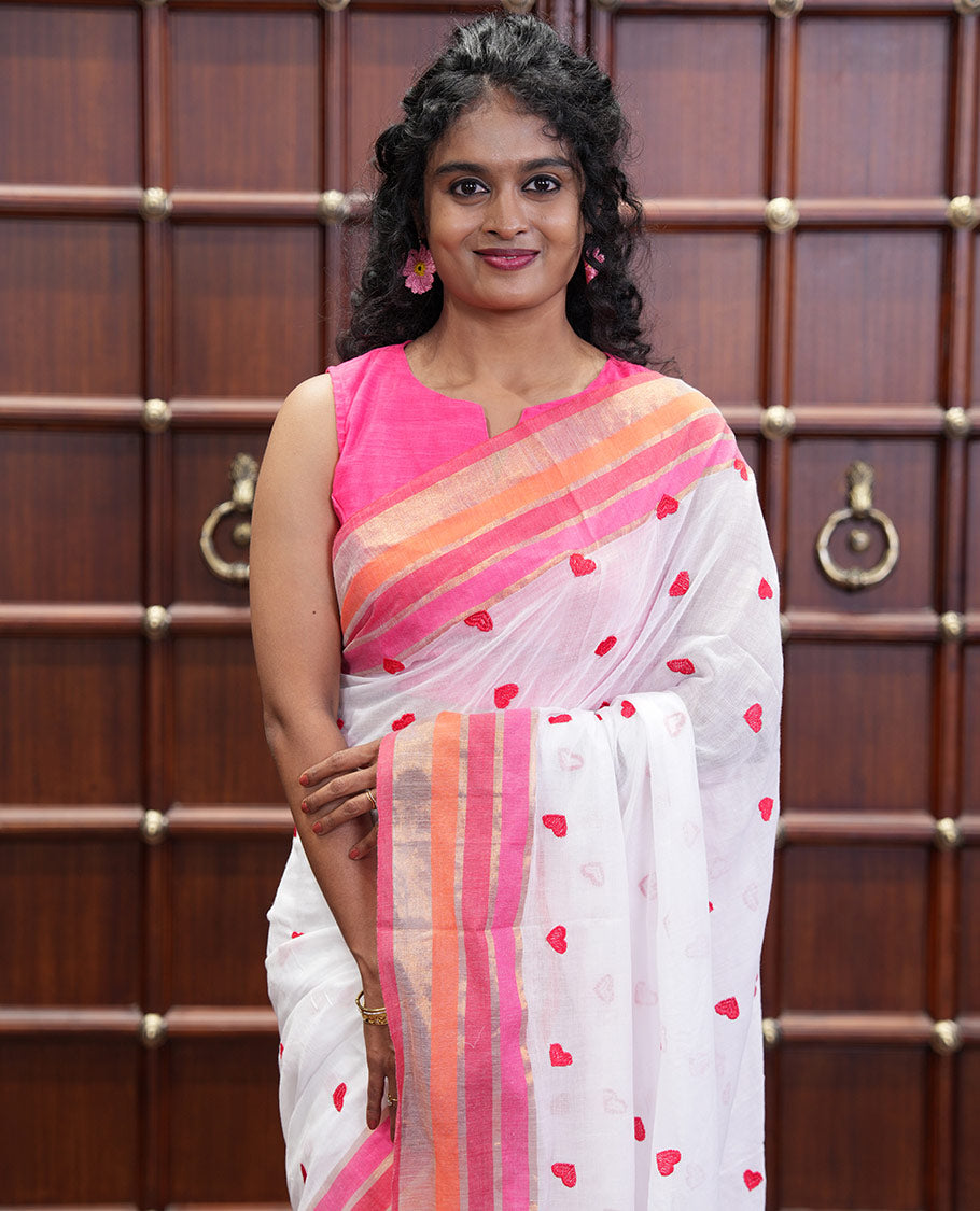 White Khadi Mul Cotton Saree, Artfully Designed Heart Motifs Embroidered on Its Body, Complemented by a Contrast Multi-Colored Striped Border, Pallu Steeped with Heart Motifs Embroidery, and Paired with a Matching Blouse