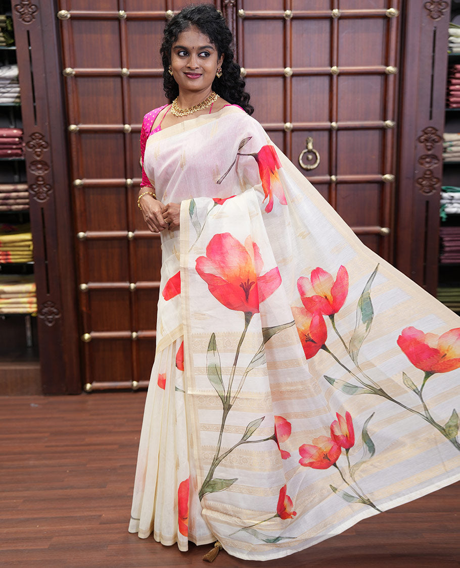 Cream Banaras Tissue Saree, Adorned with Floral Motifs Print and Zari Buttas on Its Body, Subtly Bordered, Pallu Pictures Floral Prints, and Paired with a Matching Printed Blouse