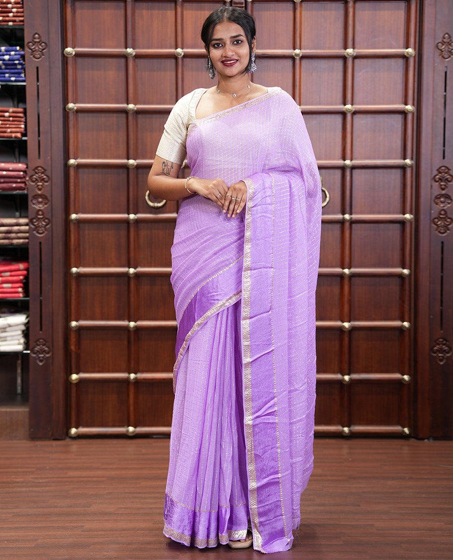 Scintillating Lavender Viscose Georgette Saree Gleamed Up with Checked Design on Its Body, Highlighted by a Double-Pet Border, Zari Checked Design Pallu, and Paired with a Matching Blouse