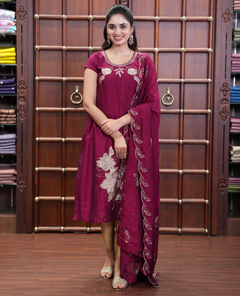 Wine Material Chudidhar Set, Highlighted with an Floral Motifs Embroidered on its Vichitra Silk Top, Plain Santoon Bottom, and Vichitra Silk Dupatta of Leaf Motifs Embroidery