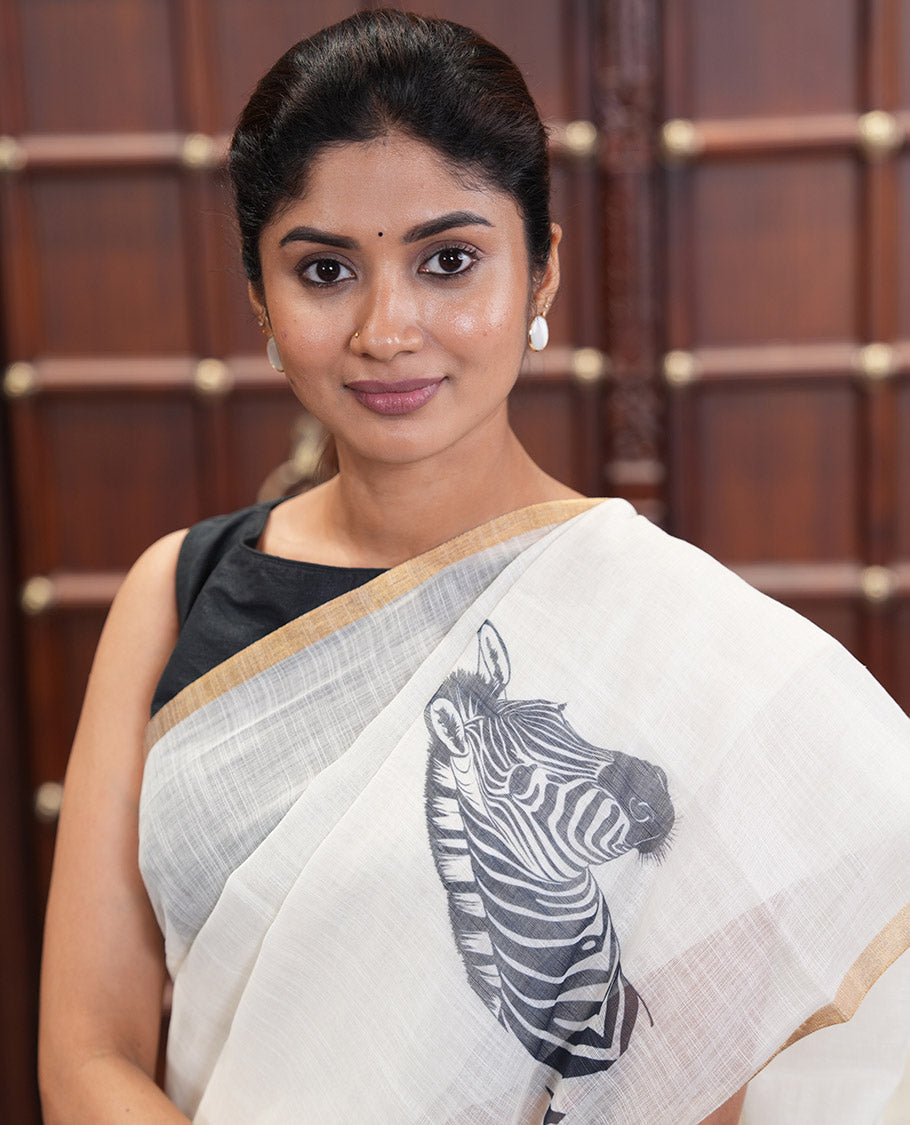 Off-white Linen Cotton Saree, Accentuated with Zebra Motifs Print, A Subtle Piping Border, Zebra Printed Pallu, and Comes with a Contrast Blouse