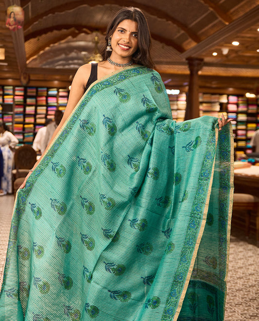 Light blue flower motifs tussar saree with contrast floral design border & floral design pallu