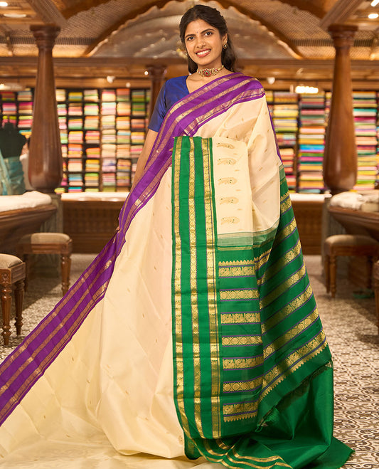 White floral buttas kancheepuram silk saree with contrast ganga jamuna, korvai border of thilakam mokku, poo chakram, mayil design & zari design pallu