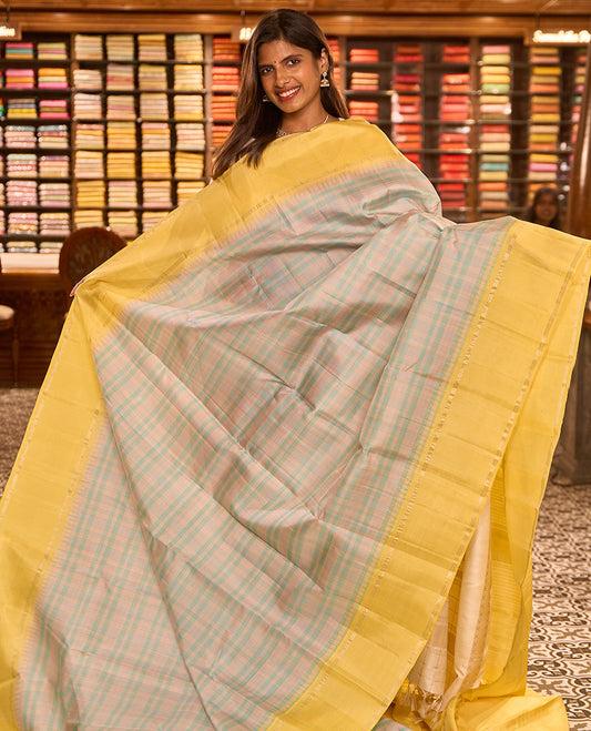 Pastel green thread checked silk saree, contrast yellow rettai pettu zari pillaiyar mokku border & zari weave pallu