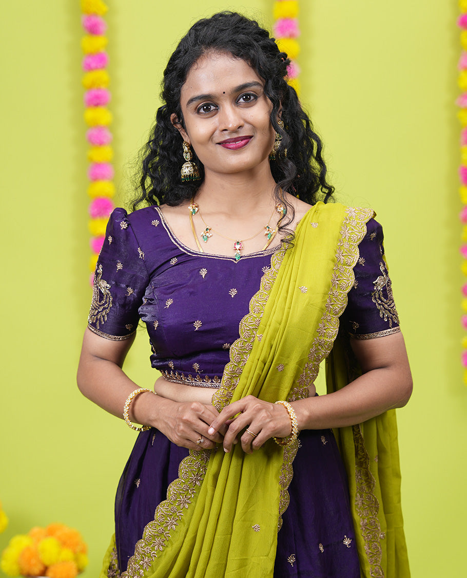 Violet half-saree, buttas and flora-fauna embroidered bordered velvet organza skirt, a matching velvet organza blouse, and a contrast embroidered scallop syska georgette dhavanif