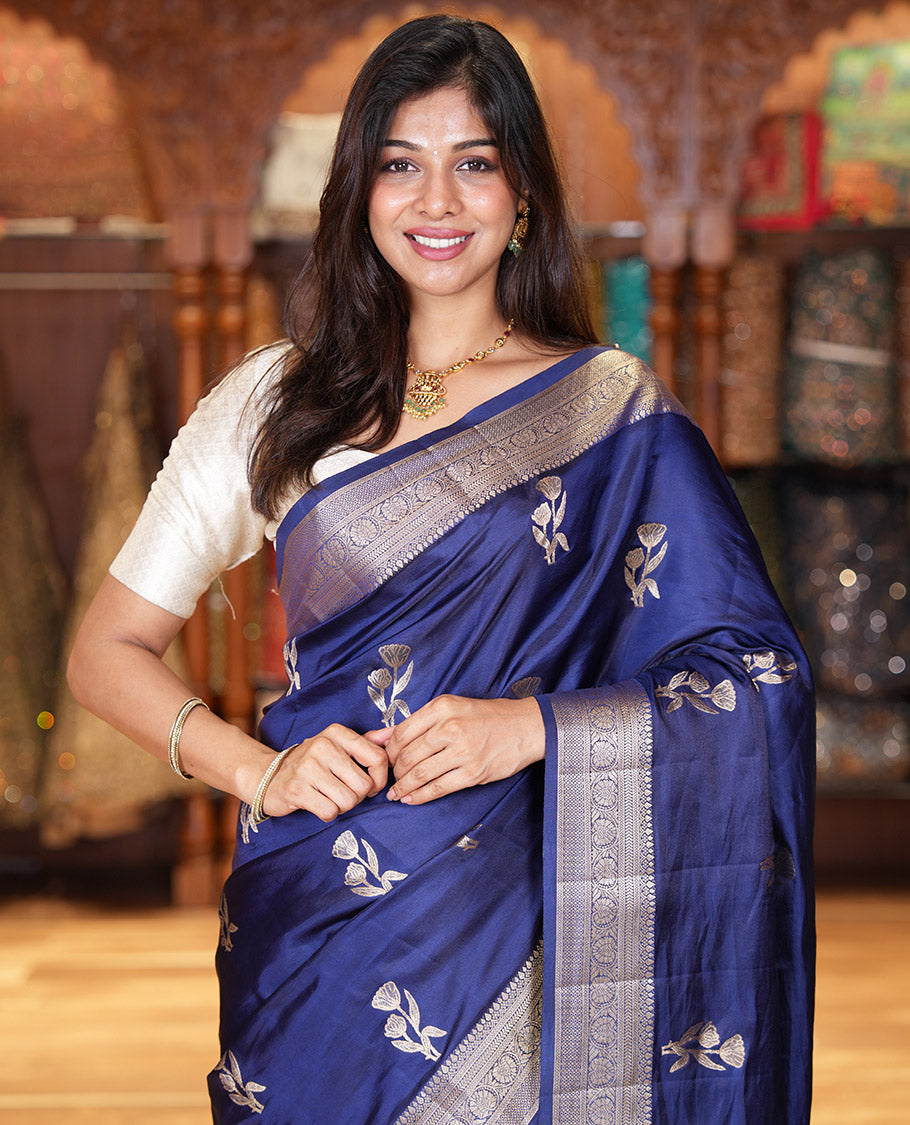 Navy Blue Semi-Banaras Satin Silk Saree, Dazzled with Floral Zari Buttas Across Its Body, Highlighted by Traditional Zari Design Border, Grand Zari Woven Palu of Jaal Designs, and Paired with a Matching Blouse