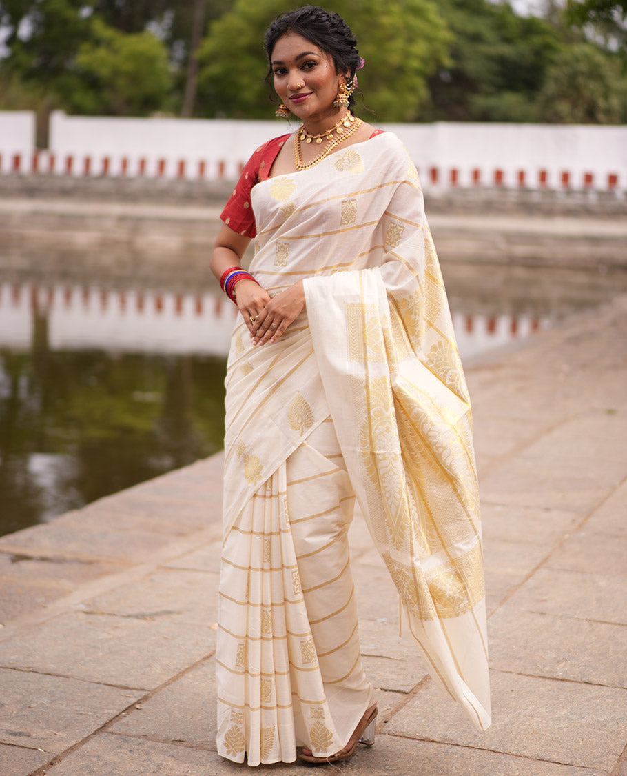 Cream Kerala Cotton Saree, Delicately Woven with Zari Stripes and Buttas, Highlighted by an Intricate Pallu and a Matching Blouse