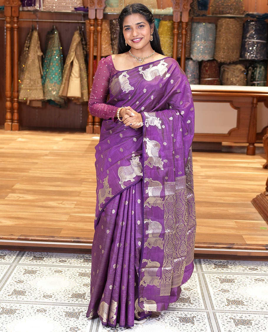 Violet Art Tussar Saree, Delicately Woven with Gold Zari Buttas All Over Its Body, Highlighted by a Zari Border of Pichwai Cow Motifs, Grandly Woven Pallu, and Paired with a Matching Blouse