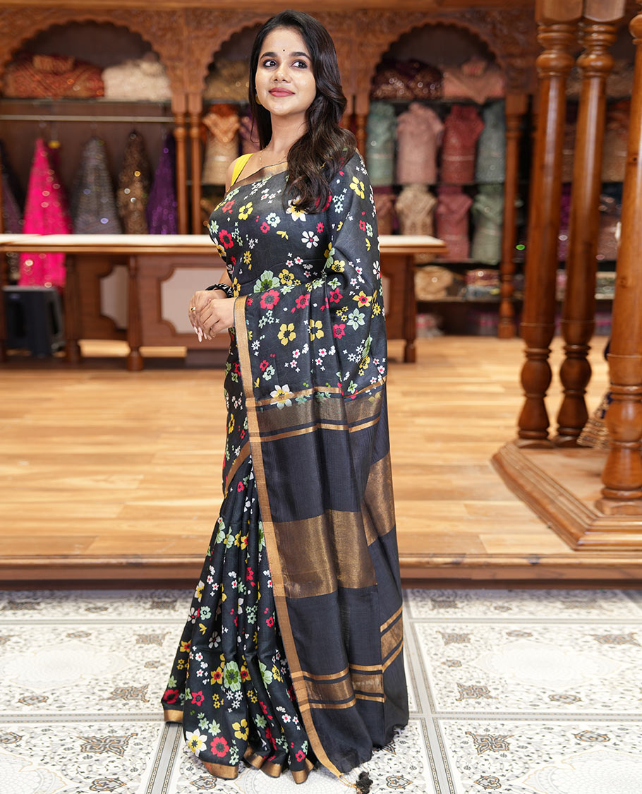 Black colorful floral printed banana pith saree, piping zari border, zari decked pallu, and a contrast floral printed blouse