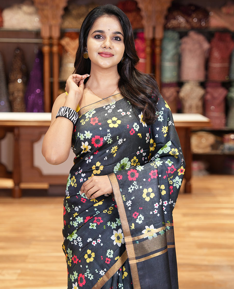 Black colorful floral printed banana pith saree, piping zari border, zari decked pallu, and a contrast floral printed blouse