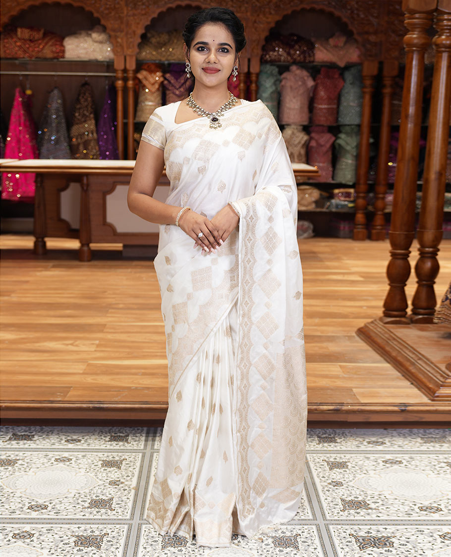 Borderless white zari buttas and diamond buttas mushru silk saree, intricately designed pallu, and a matching blouse