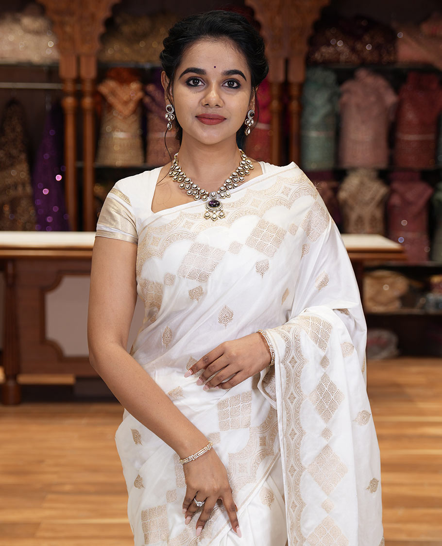 Borderless white zari buttas and diamond buttas mushru silk saree, intricately designed pallu, and a matching blouse