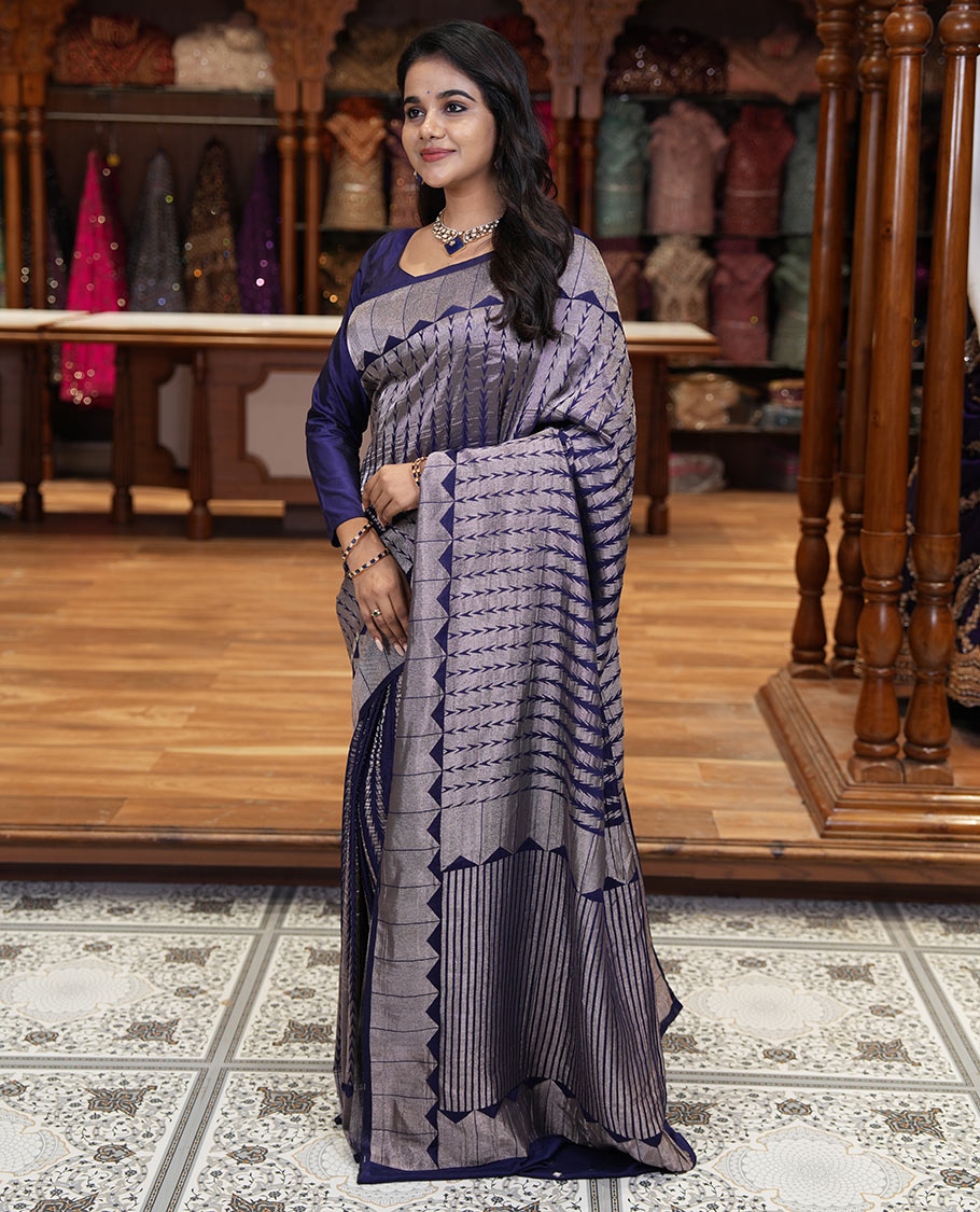 Navy blue zari geometric fancy crepe saree, temple zari border, zari striped pallu, and a matching buttas woven blouse