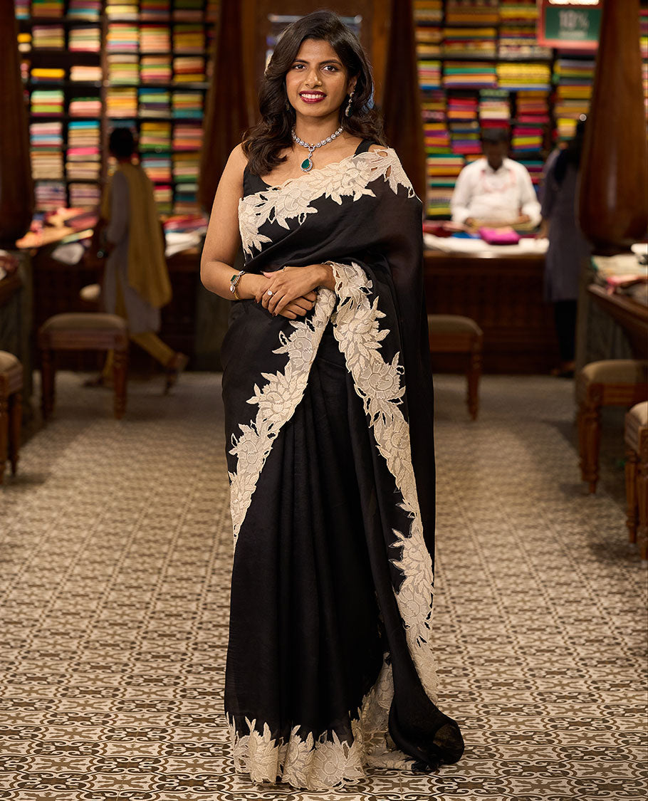 Black organza saree with contrast floral embroidery, cut work border