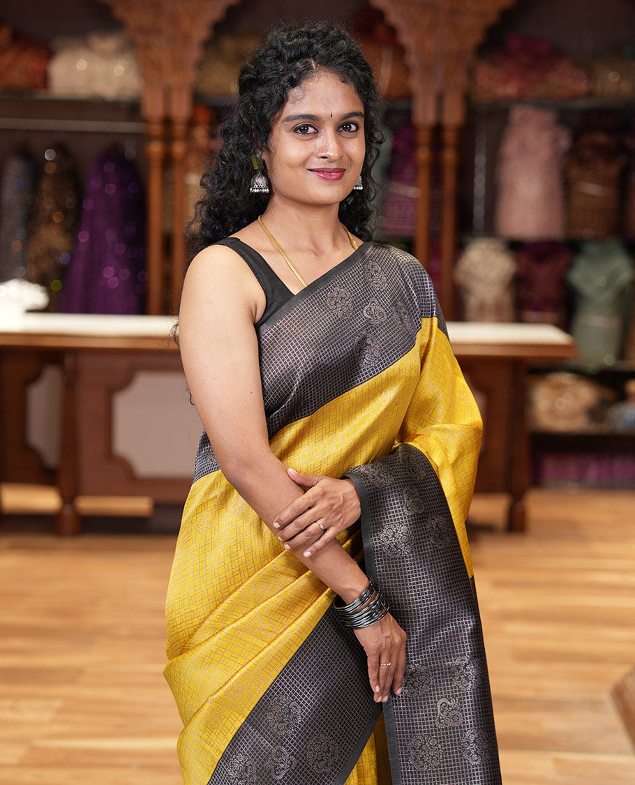 Yellow zari buttas and checked kanchi silk saree, contrast border of zari buttas, and checks, intricate pallu, and contrast zari bordered blouse