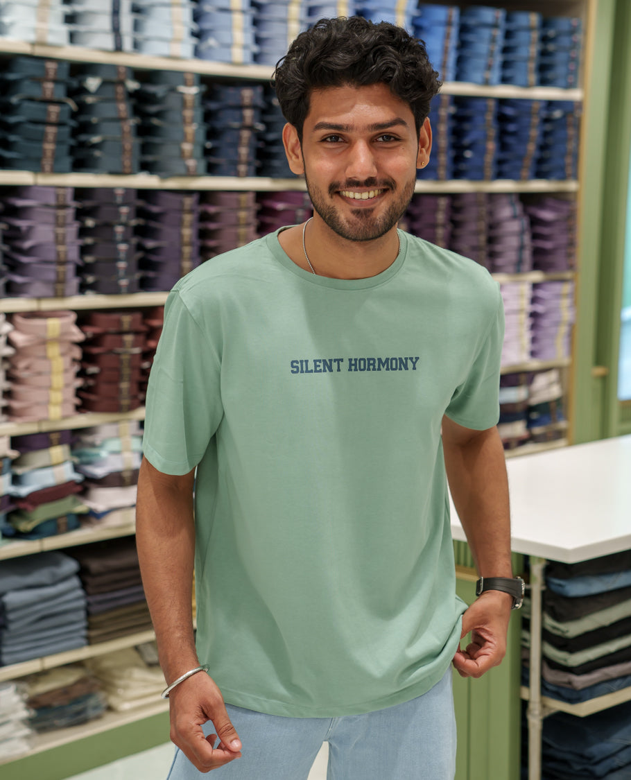 Green Cotton-Blended T-Shirt Comes with an Tree-Motifs Back Print, Crew Neck, Half Sleeves, Oversized Fit, and Regular Length