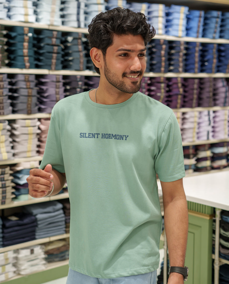 Green Cotton-Blended T-Shirt Comes with an Tree-Motifs Back Print, Crew Neck, Half Sleeves, Oversized Fit, and Regular Length