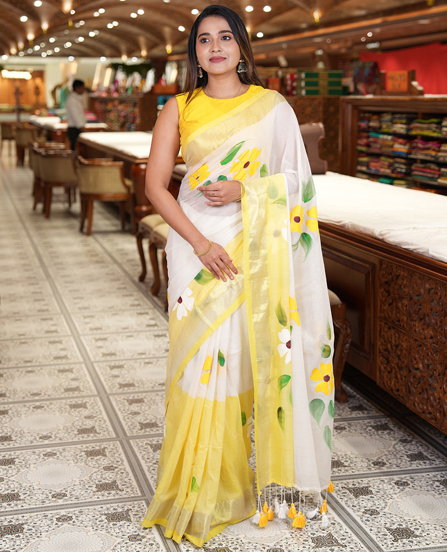 Cream and Yellow Khadi Mul Cotton Saree, Adorned with Hand-Brush Painting-Style Floral Block Printed Body, a Subtle Gold Zari Border, a Self-Pallu, and Paired with a Matching Blouse