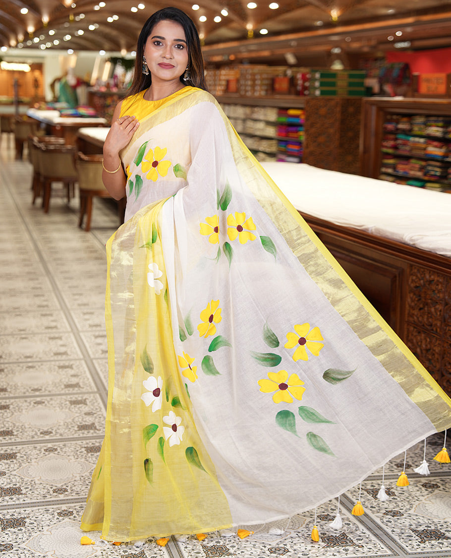 Cream and Yellow Khadi Mul Cotton Saree, Adorned with Hand-Brush Painting-Style Floral Block Printed Body, a Subtle Gold Zari Border, a Self-Pallu, and Paired with a Matching Blouse