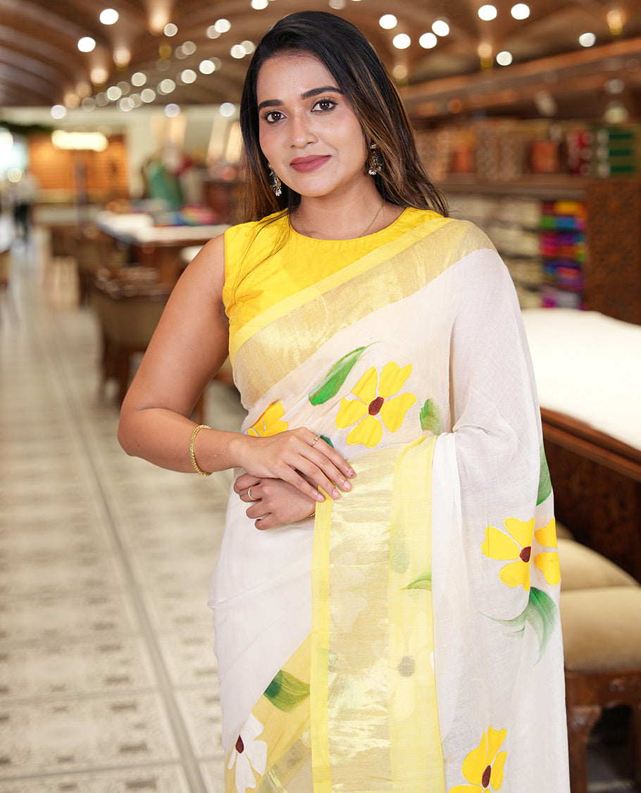 Cream and Yellow Khadi Mul Cotton Saree, Adorned with Hand-Brush Painting-Style Floral Block Printed Body, a Subtle Gold Zari Border, a Self-Pallu, and Paired with a Matching Blouse