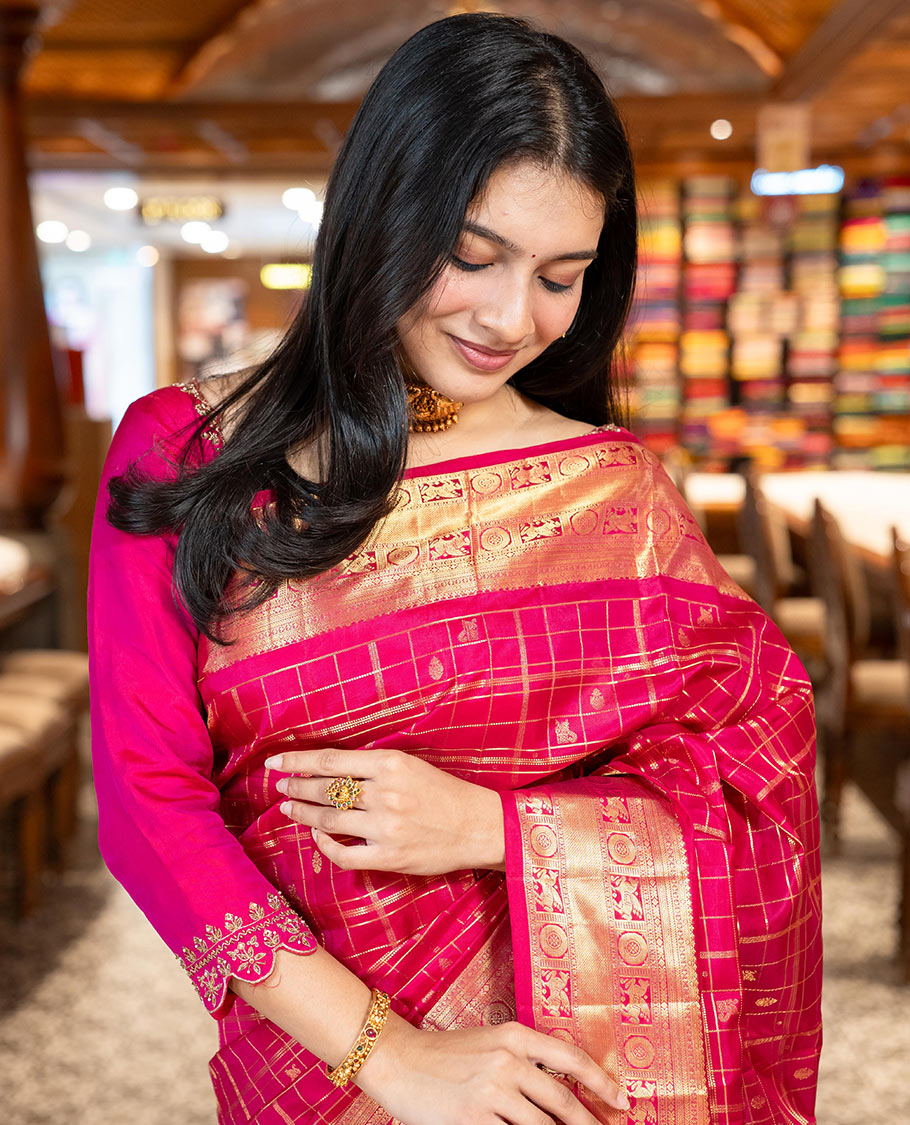 Pink Vasundhara Silk Saree Gracefully Embellished with Zari Butta Enclosed Checks, Complemented with a Zari Border of Kuthirai and Chakram Designs, Pallu of Intricate Zari-Weave, and Paired with a Matching Blouse
